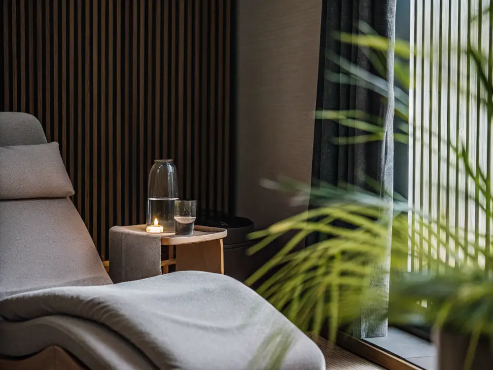 A calm wellness relaxation lounge with a soft recliner and warm daylight